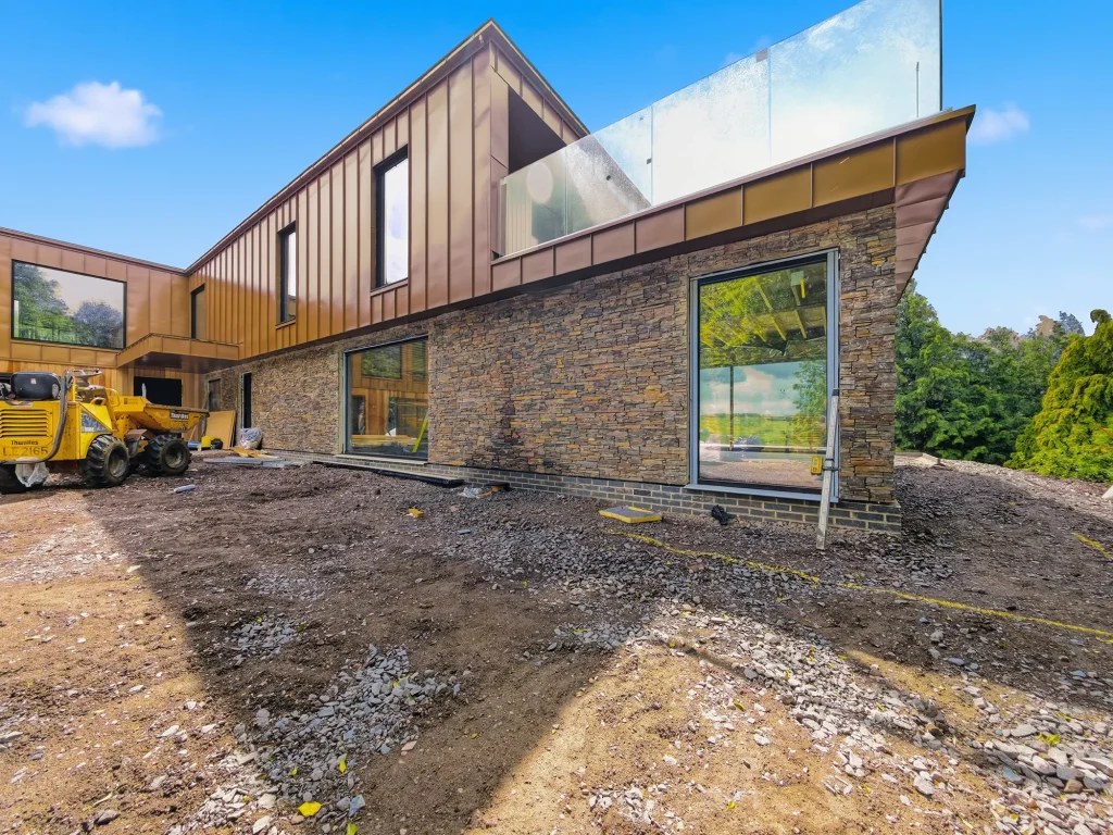 Modern looking house with glass balcony